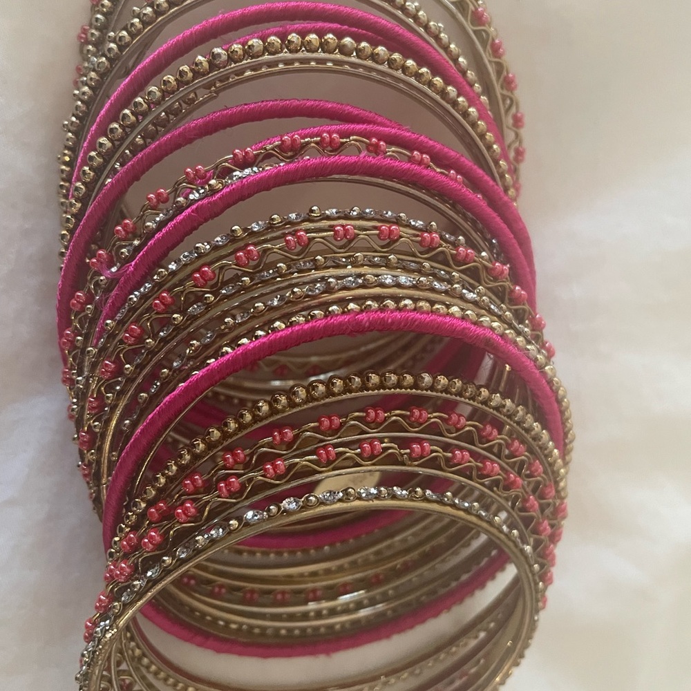 Pink and gold bangles from Seasonal Whispers Tribeca NYC. Set of 24. As new